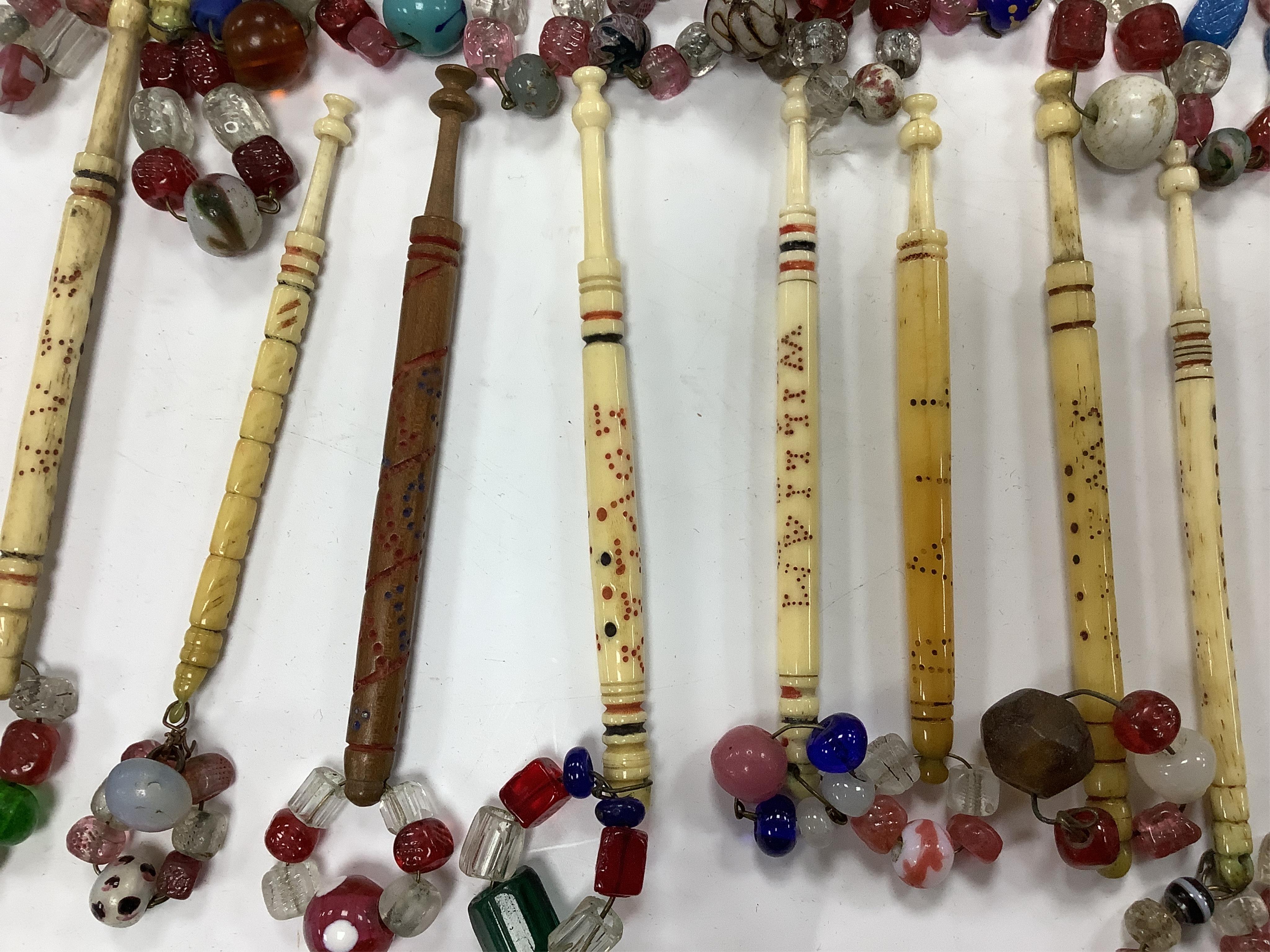 A collection of 19th century named and motto bone lace bobbins, including three named Barry bobbins with a related EB red embroidered monogram to lace edged hankie.(31 bobbins) Condition- light rust staining to hankie, b